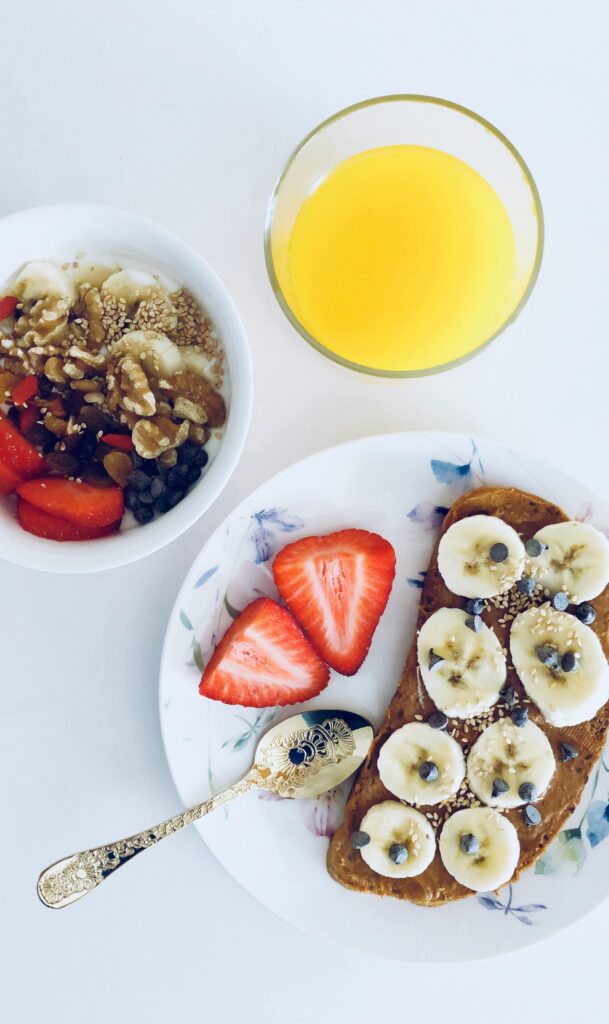 Delicious breakfast plate with toast, fresh fruit, and orange juice