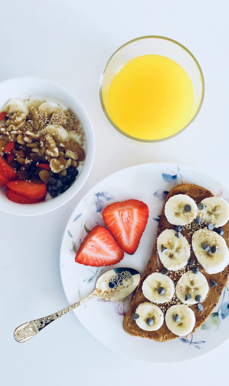 Delicious breakfast plate with toast, fresh fruit, and orange juice